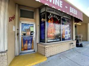 A storefront gallery with a sign for wine and beer