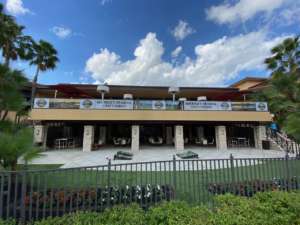 golf course outdoor bar with vinyl titos vodka banners on second floor railing