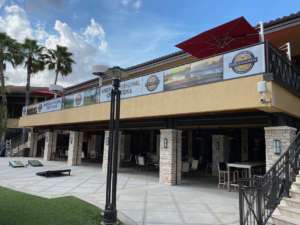 golf course outdoor bar with vinyl titos vodka banners on second floor railing