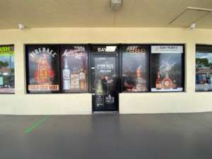 storefront window graphics showcasing several liquor brands