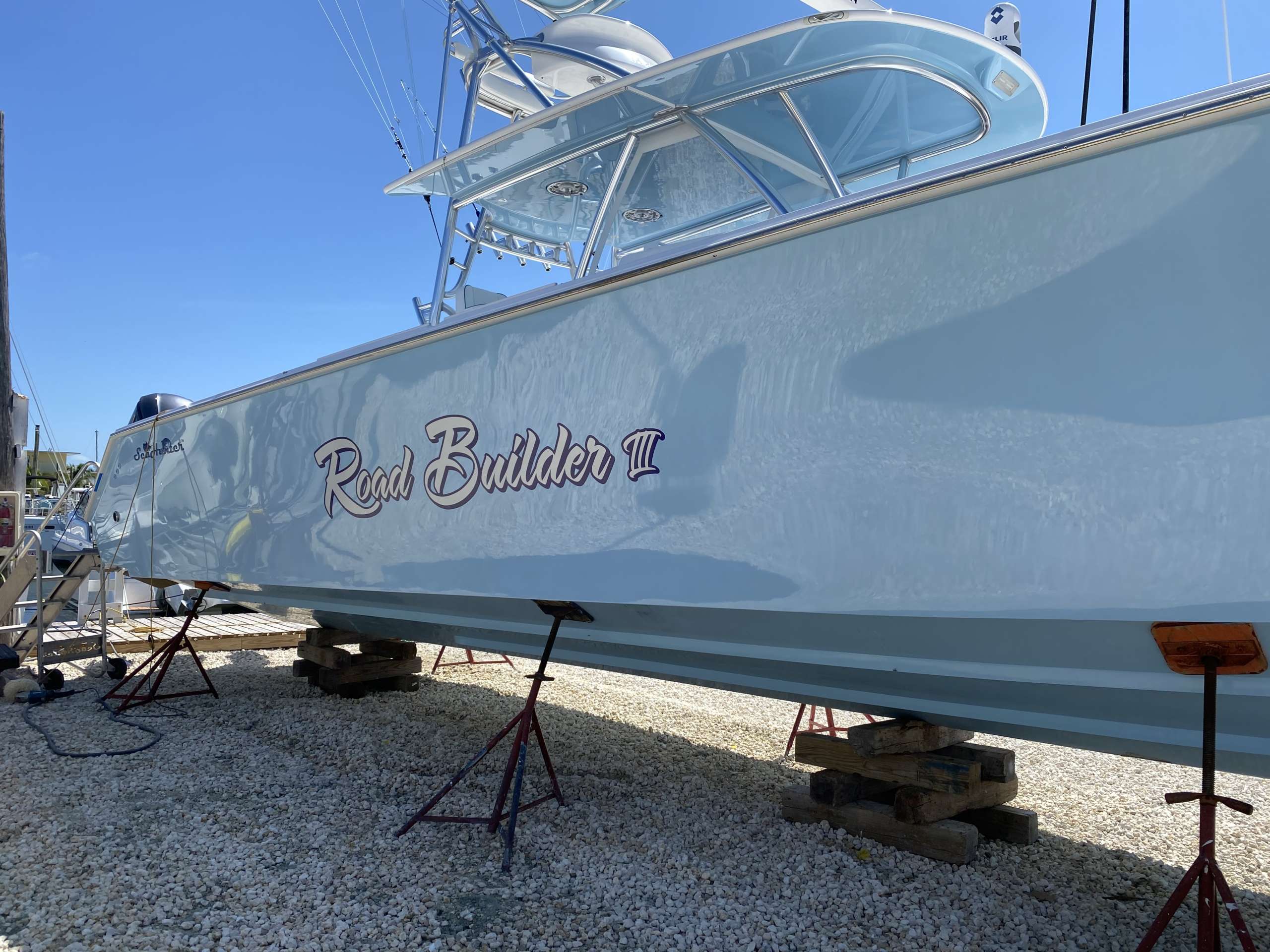 A blue boat is sitting in a gallery.